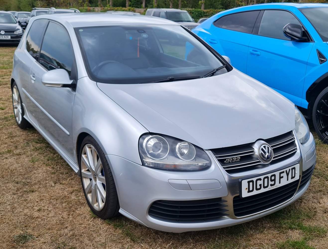 Silver 3-door hatchback with sporty front grille and round headlights