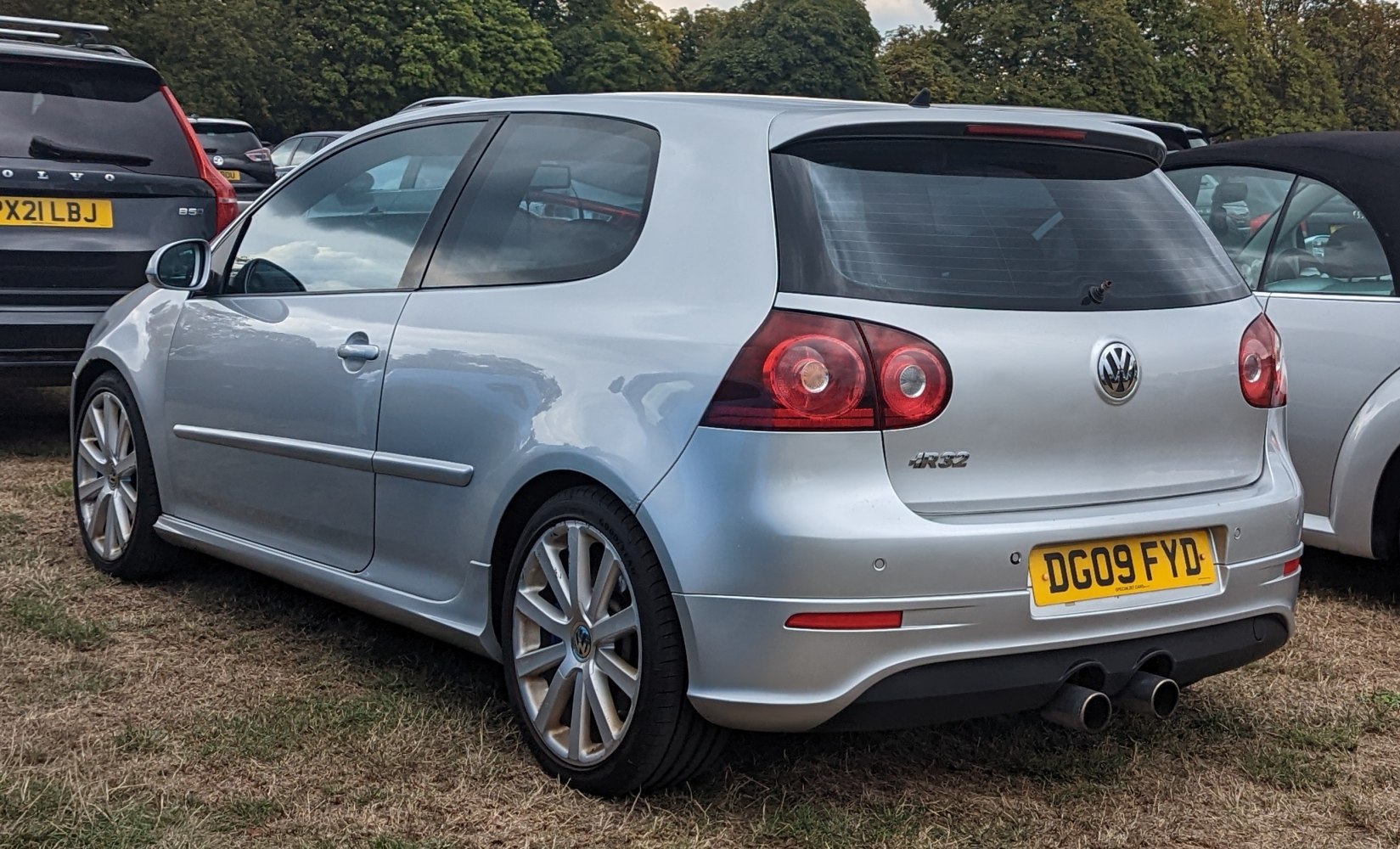 Silver 3-door hatchback with LED taillights and dual exhaust