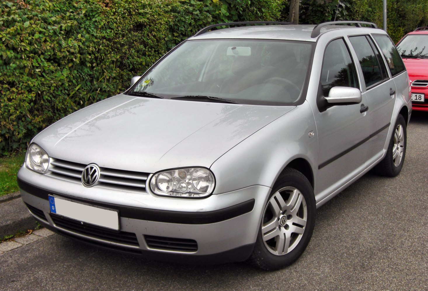 Silver station wagon with roof rails and distinct front headlights