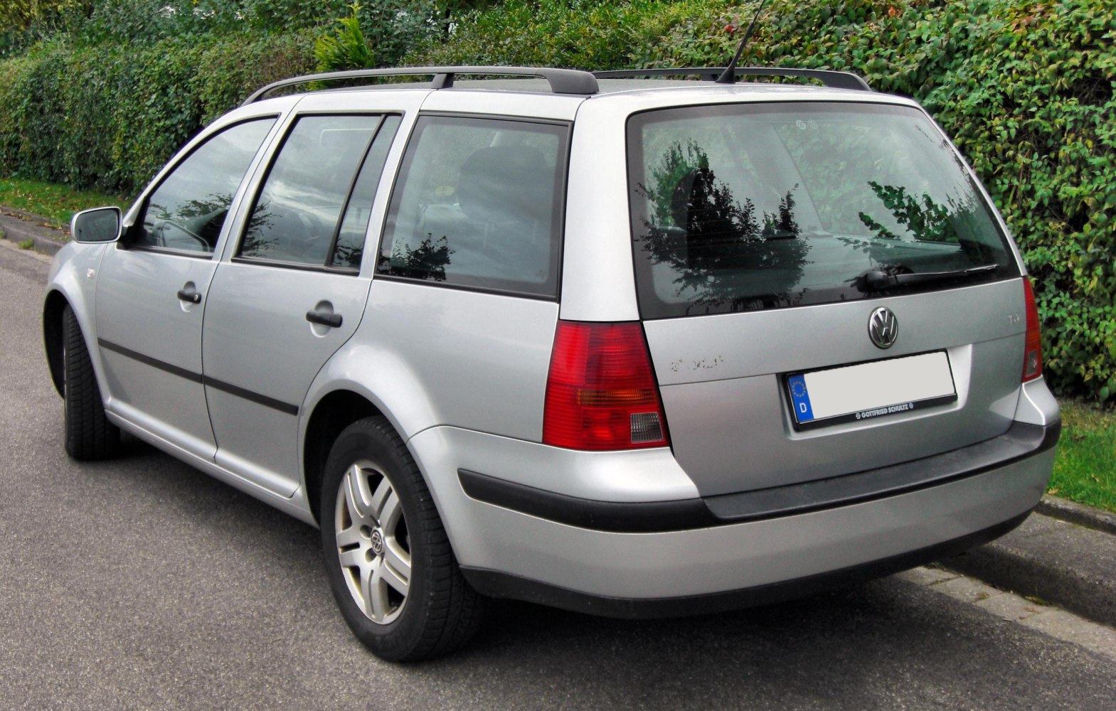 Silver station wagon rear view with roof rails and alloy wheels