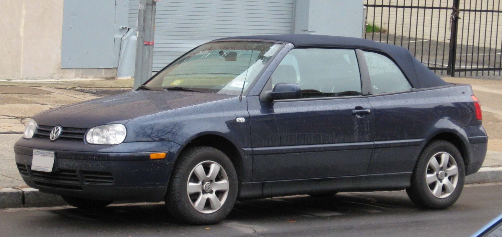 Side view of a convertible with soft top roof and alloy wheels