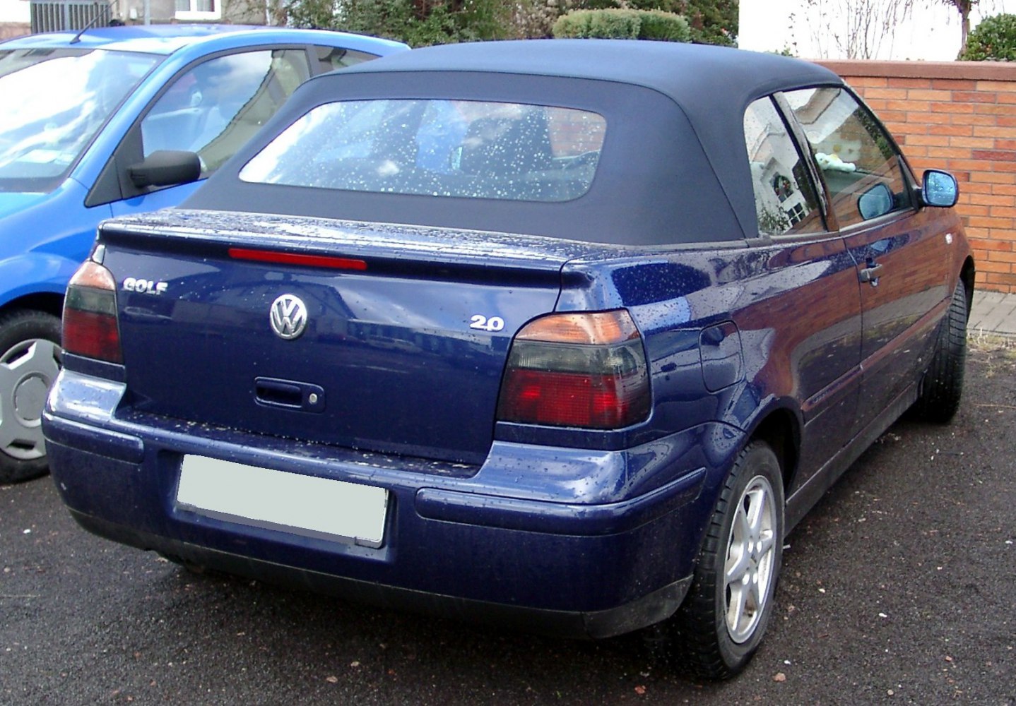 Convertible with soft top roof and rear view with engine badge