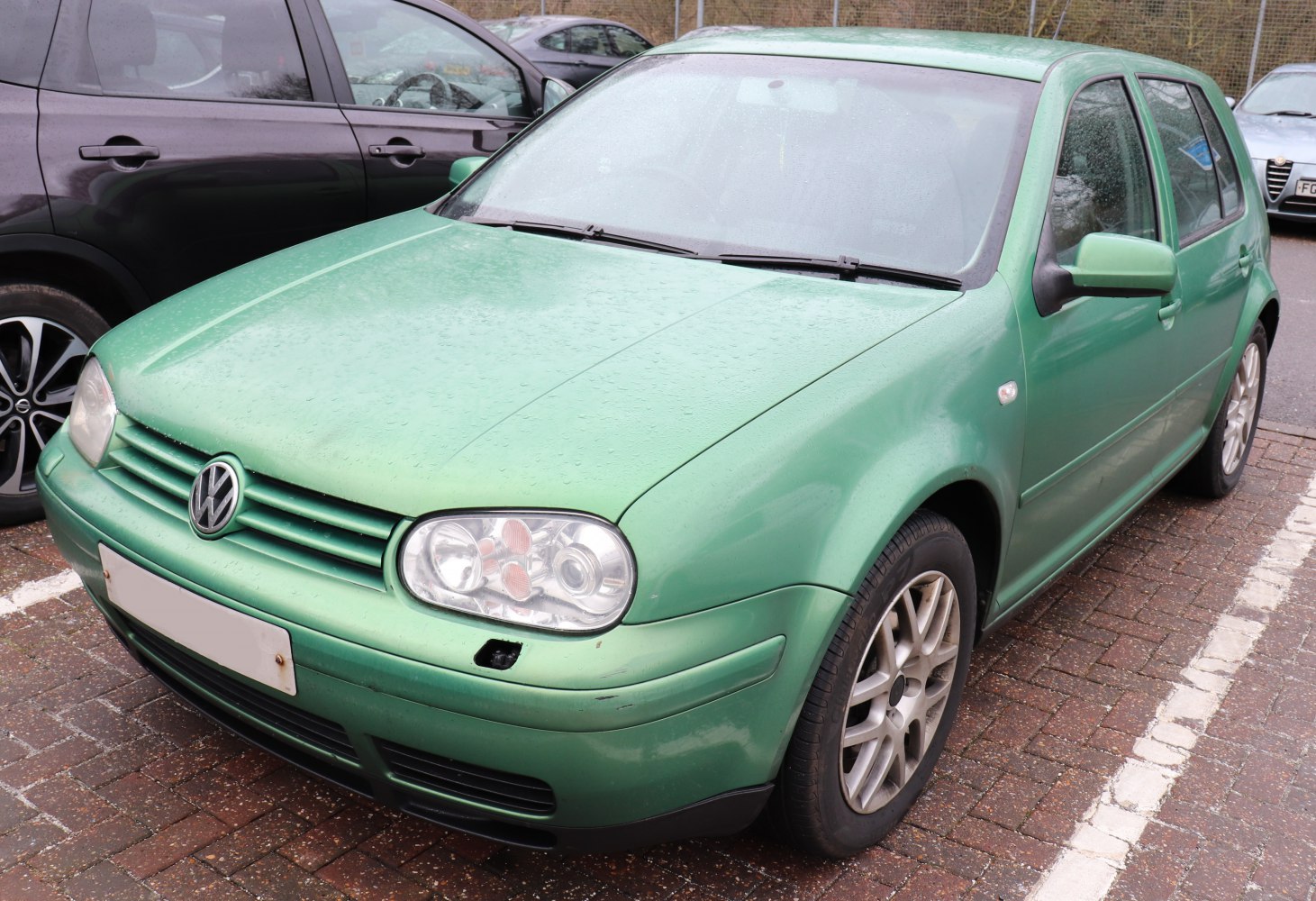 Compact hatchback with rounded headlights and multi-spoke alloy wheels