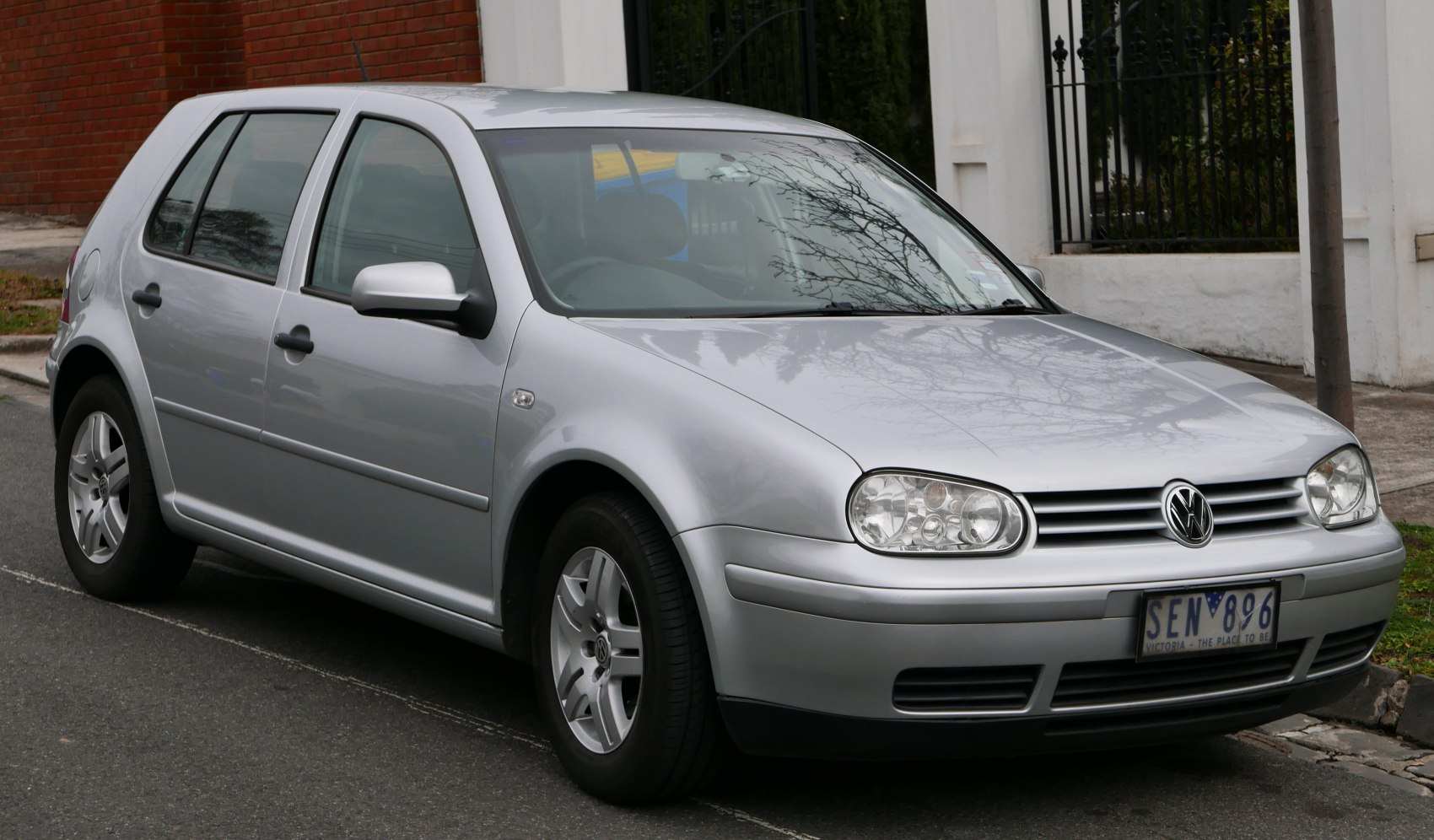 Silver hatchback car with front side view, alloy wheels, and clear headlights