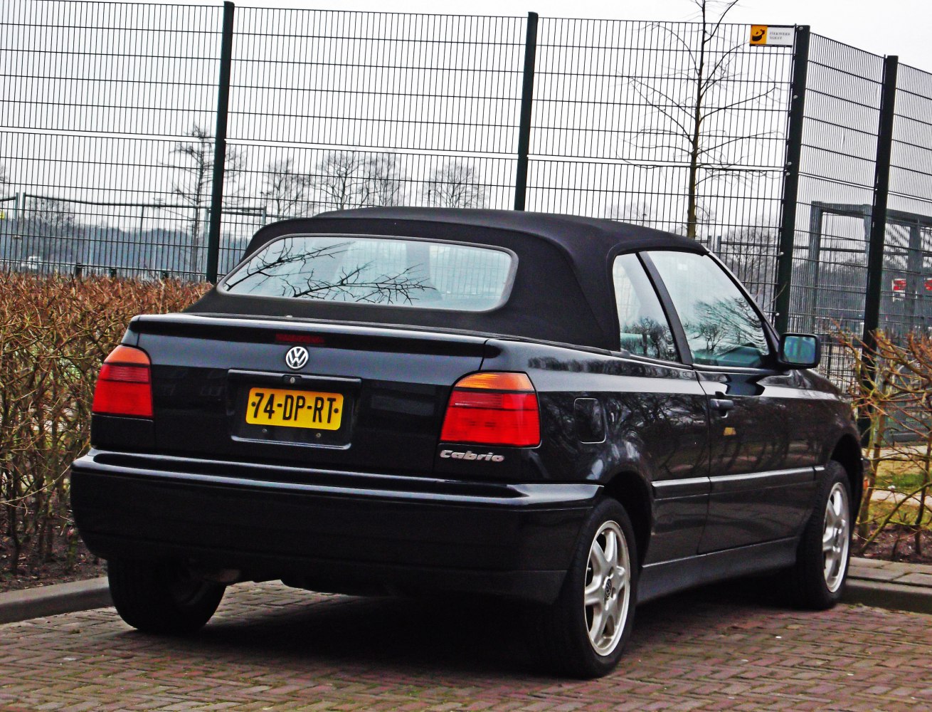Rear view of black soft top convertible with compact design