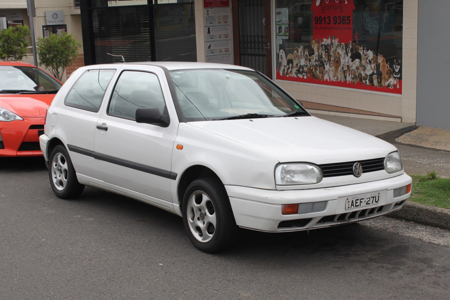 White 3-door hatchback showcasing front design and compact body.
