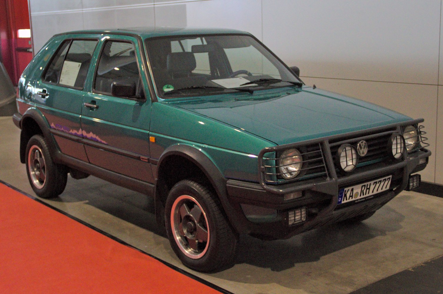 Raised suspension hatchback with off-road grille guard and protective lights