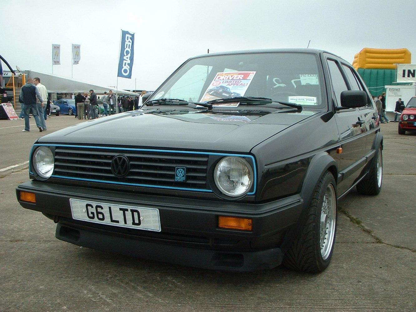 Front view of a hatchback with round headlights and classic grille.