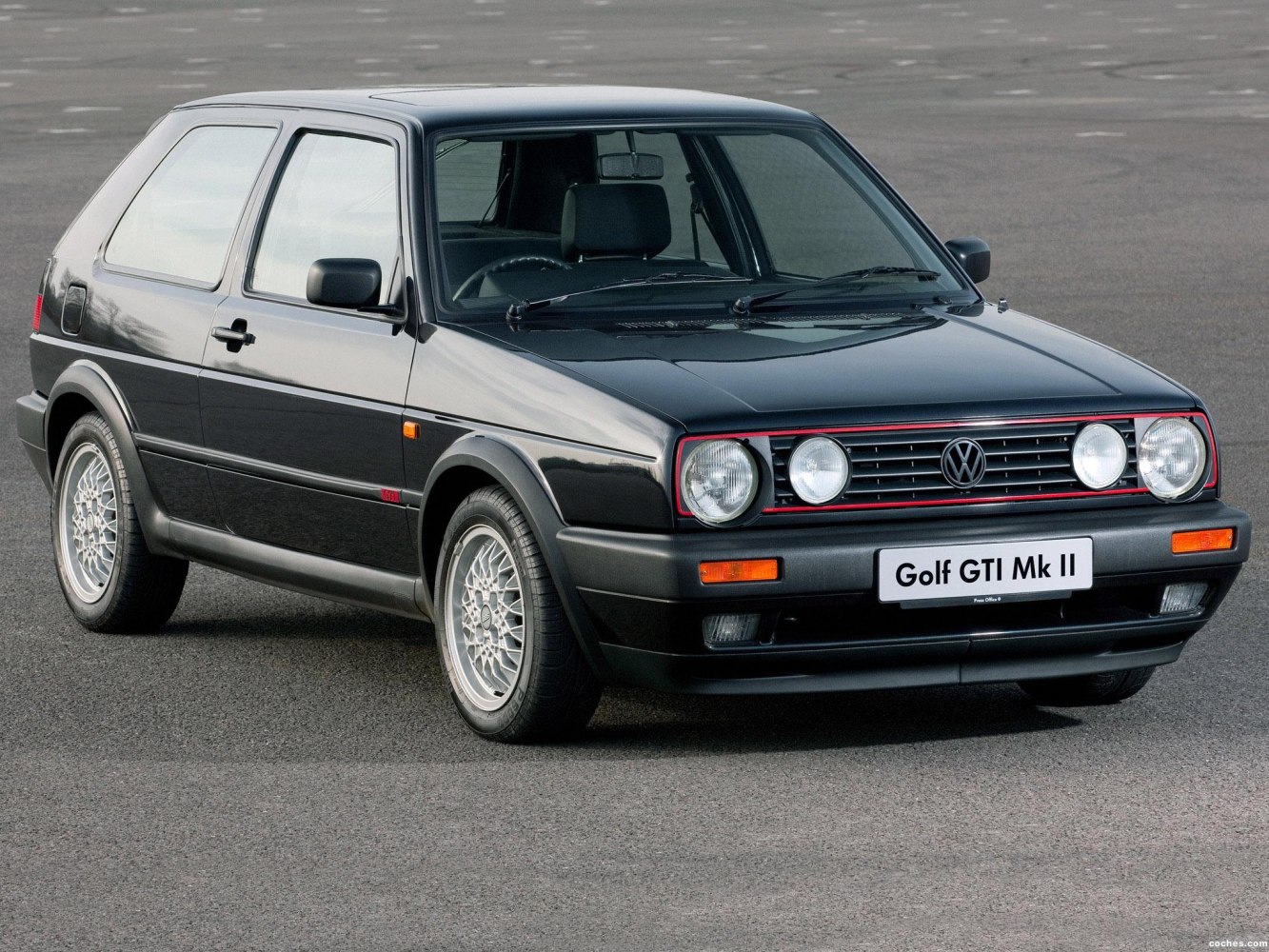 3-door compact hatchback with quad headlights and alloy wheels