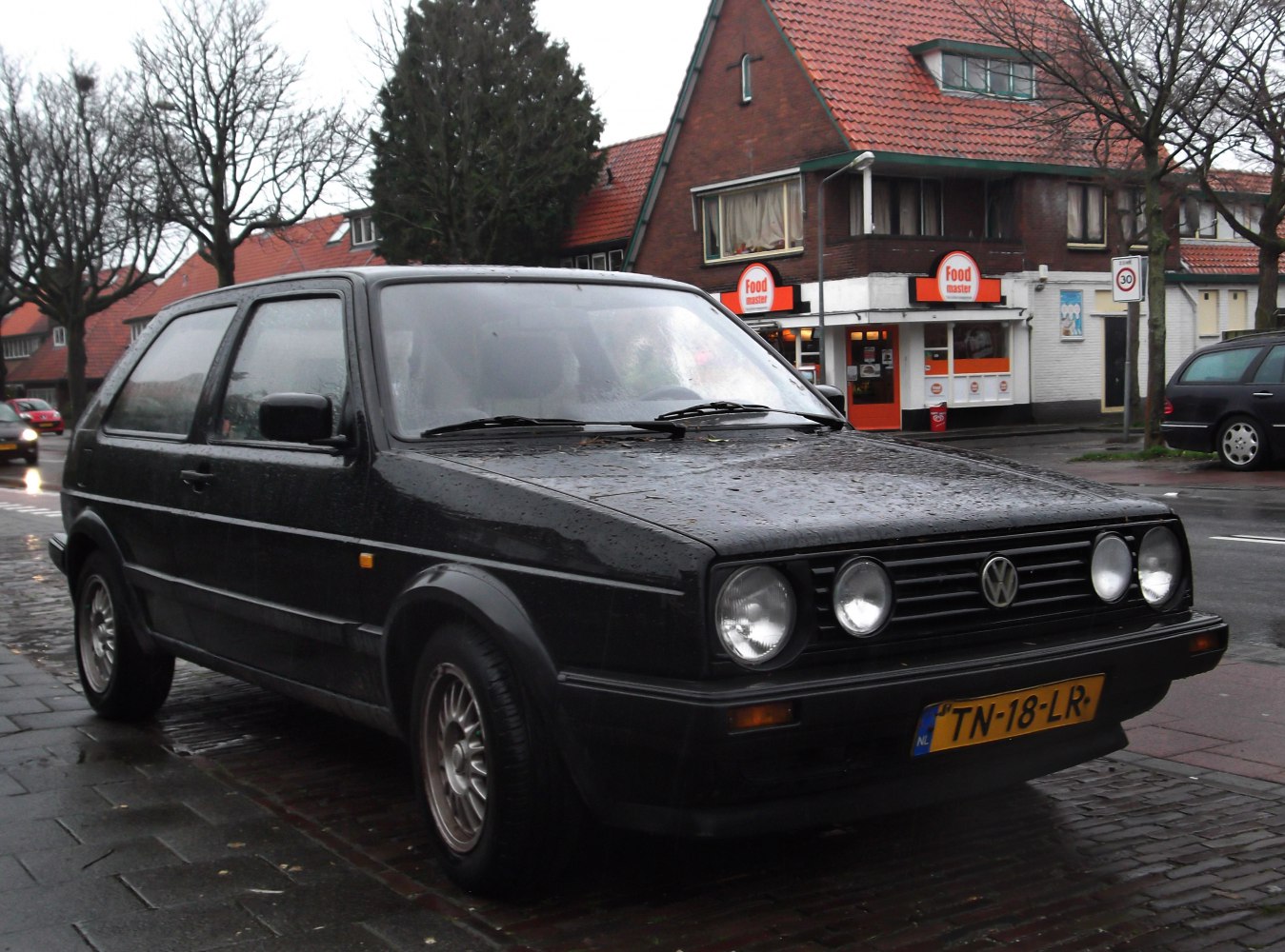 3-door hatchback with quad round headlights and alloy wheels