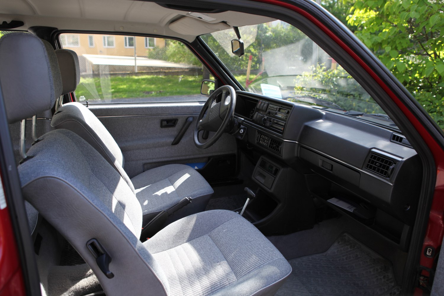 Fabric seats and vintage dashboard inside a classic vehicle