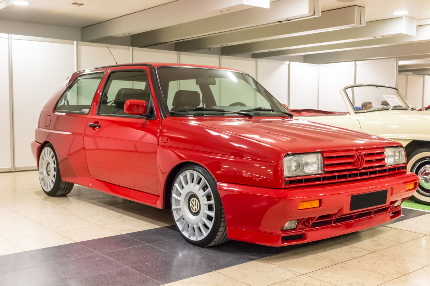 Red 3-door hatchback with aerodynamic wheels and boxy sporty design