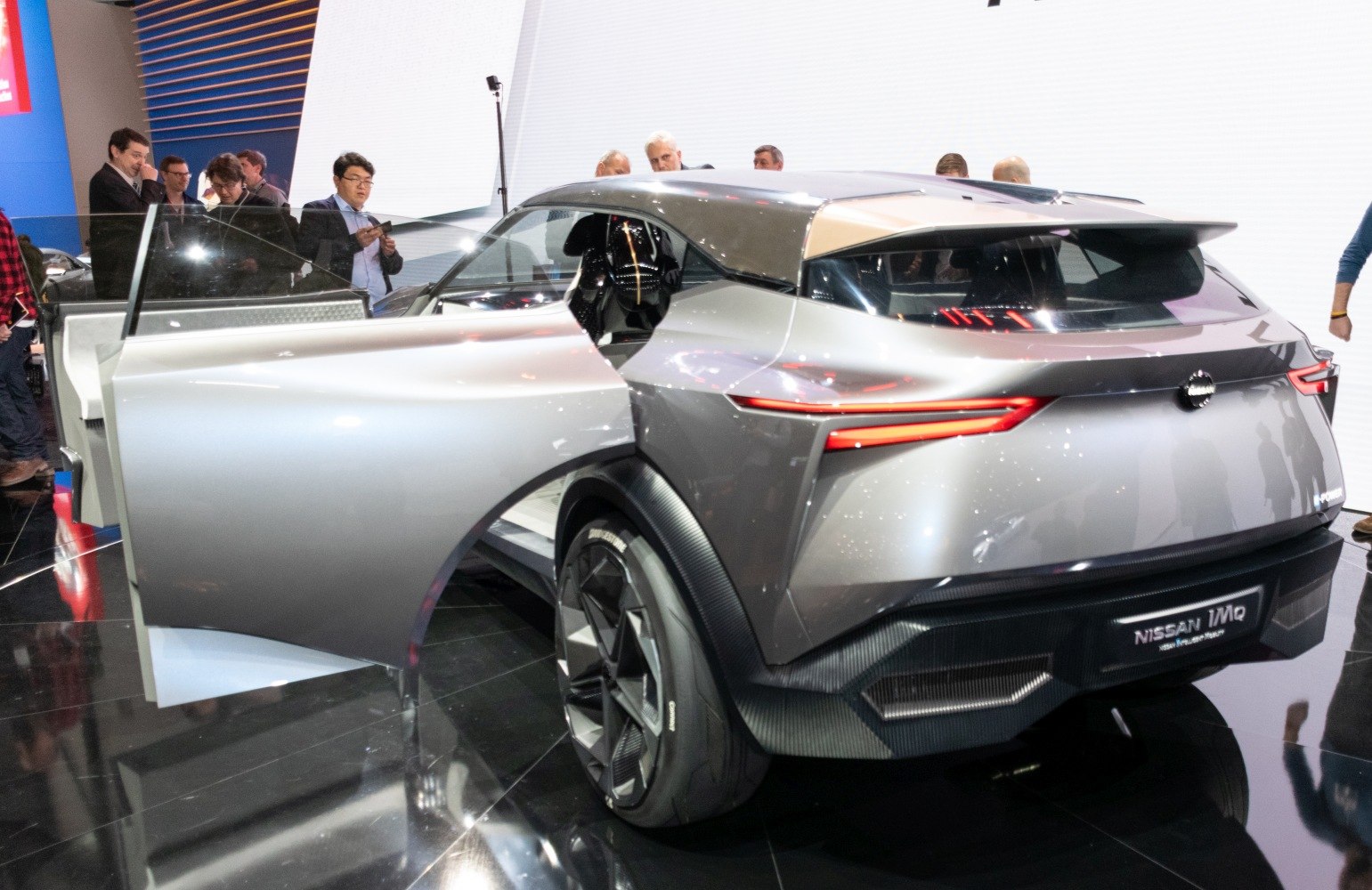 Rear view with distinctive open door and futuristic taillights