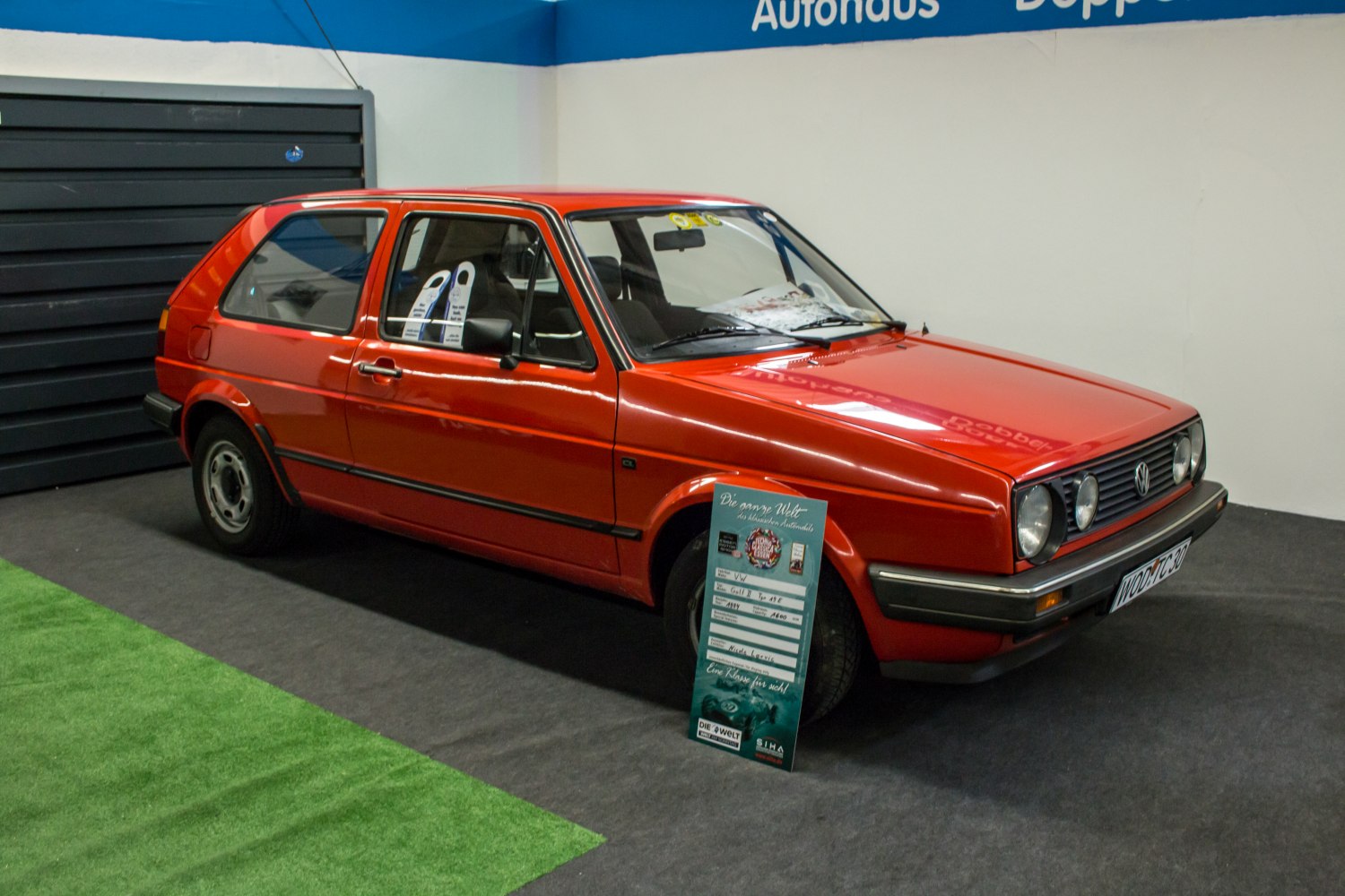 Red 3-door hatchback with boxy design and front grille