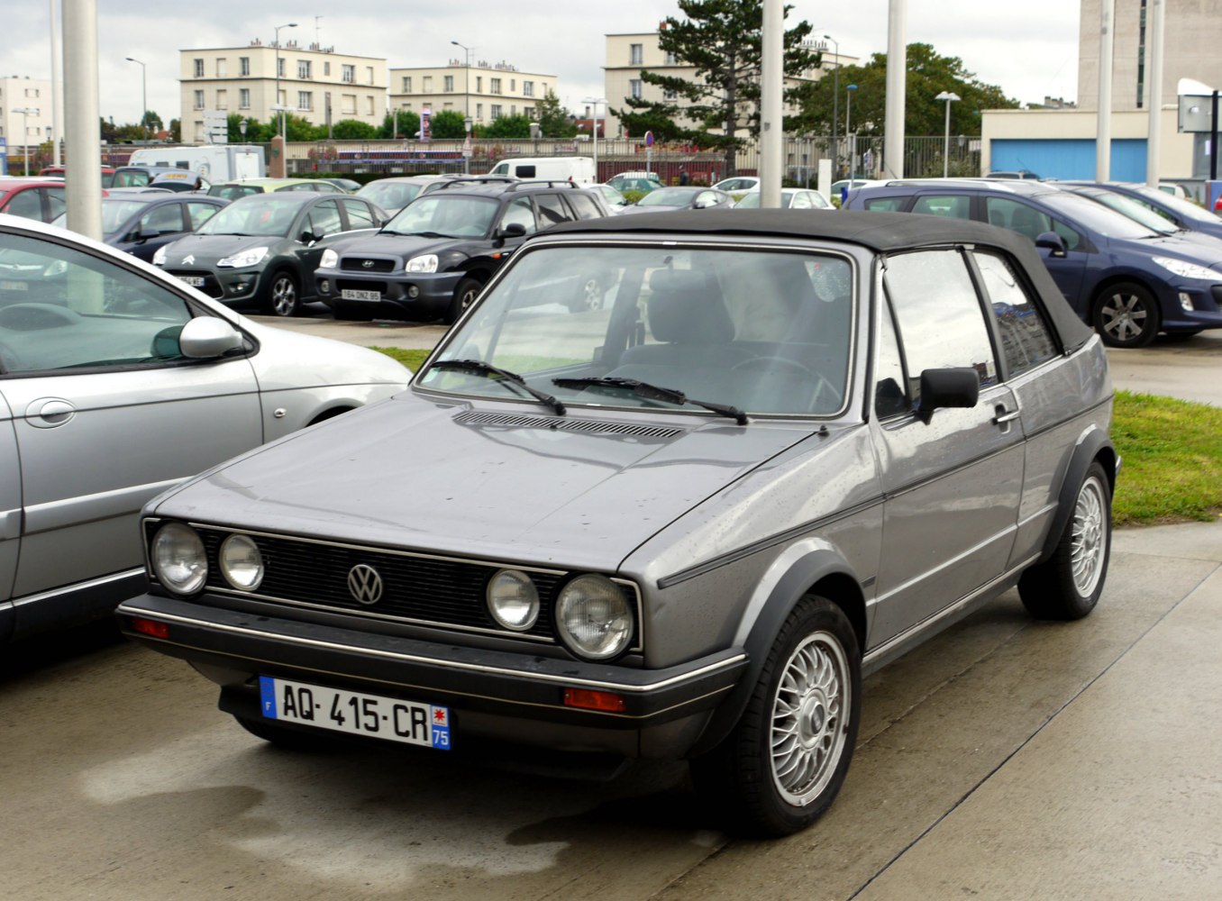 Vintage convertible with round headlights and alloy wheels
