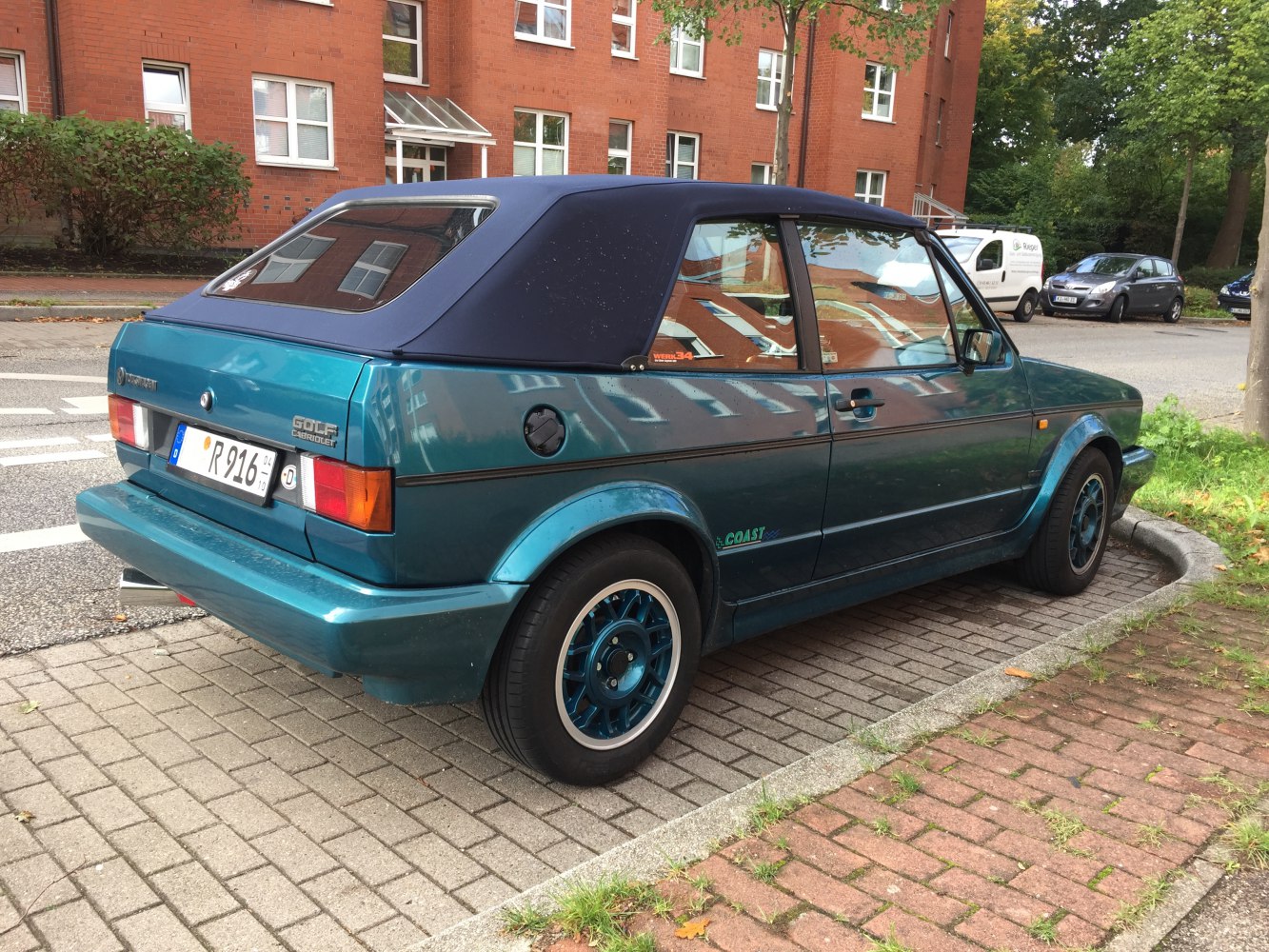 Convertible with blue fabric soft top and vintage alloy wheels