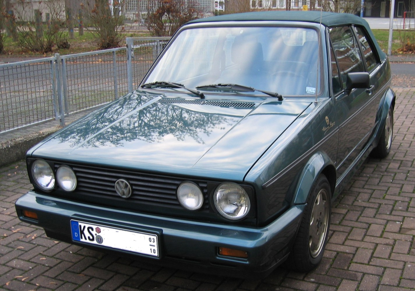 Vintage convertible with quad circular headlights and retro front grille