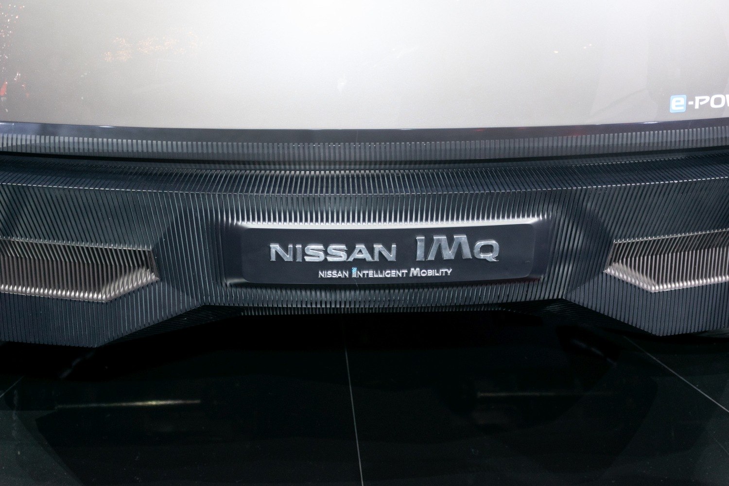 Close-up of rear textured panel with Nissan IMQ badge