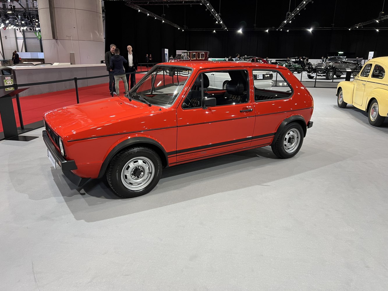 Red vintage 3-door hatchback with compact design and simple steel wheels
