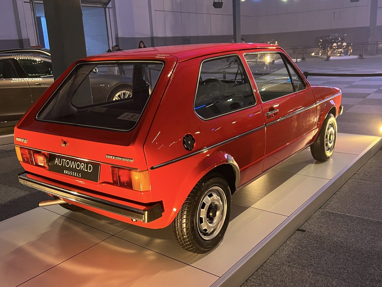 Rear angled view of vintage 3-door hatchback with distinctive taillights and classic design.