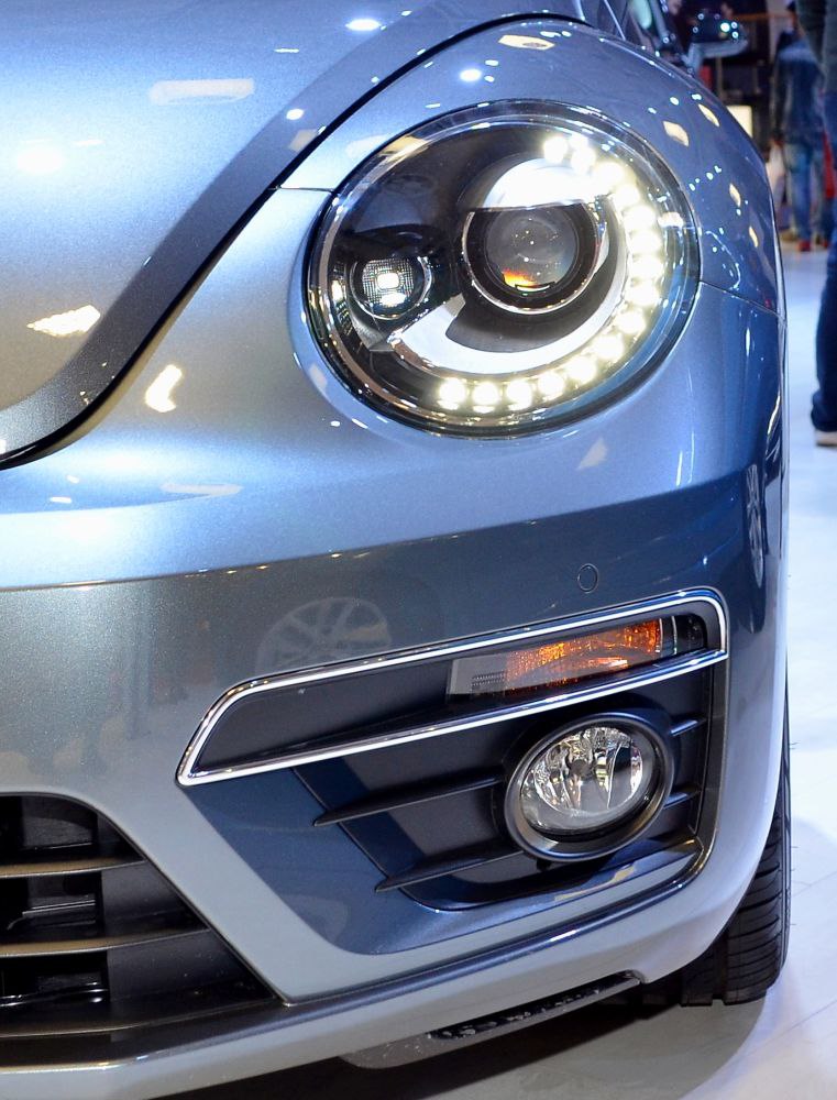 Close-up of front LED headlight and fog light on a modern car front end