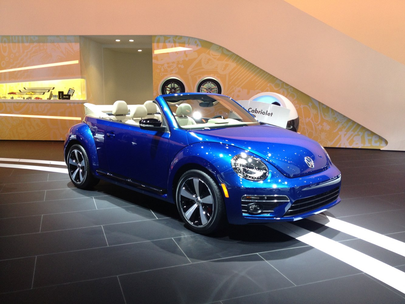 Blue convertible with cream interior and sporty wheels