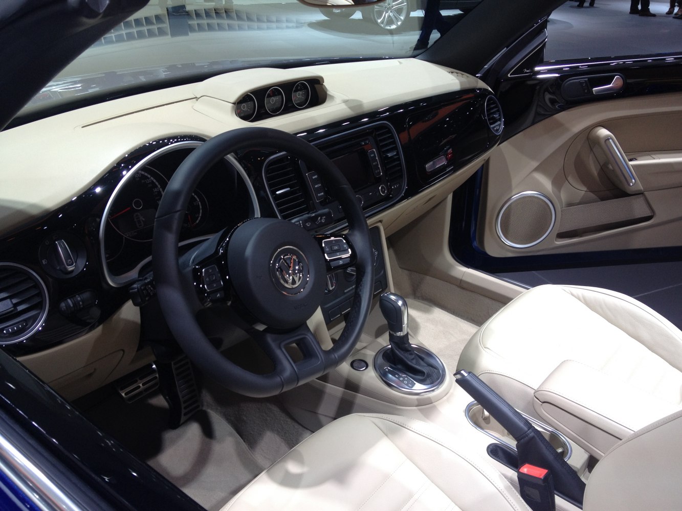 Beige leather seats and detailed dashboard with controls and steering wheel