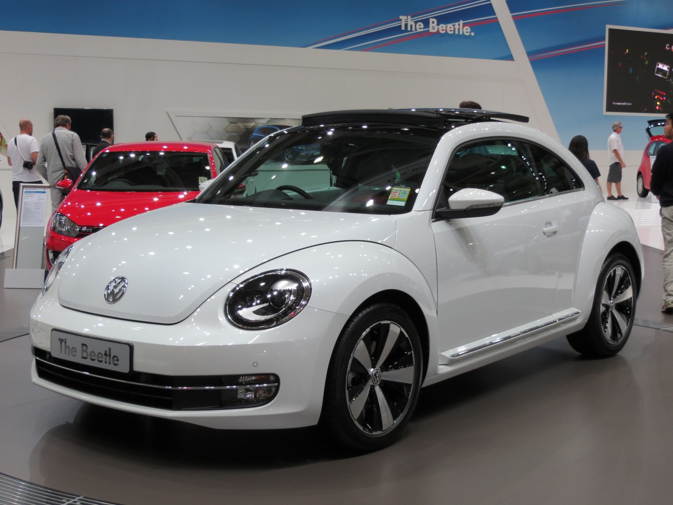 White Volkswagen Beetle with panoramic sunroof and alloy wheels.
