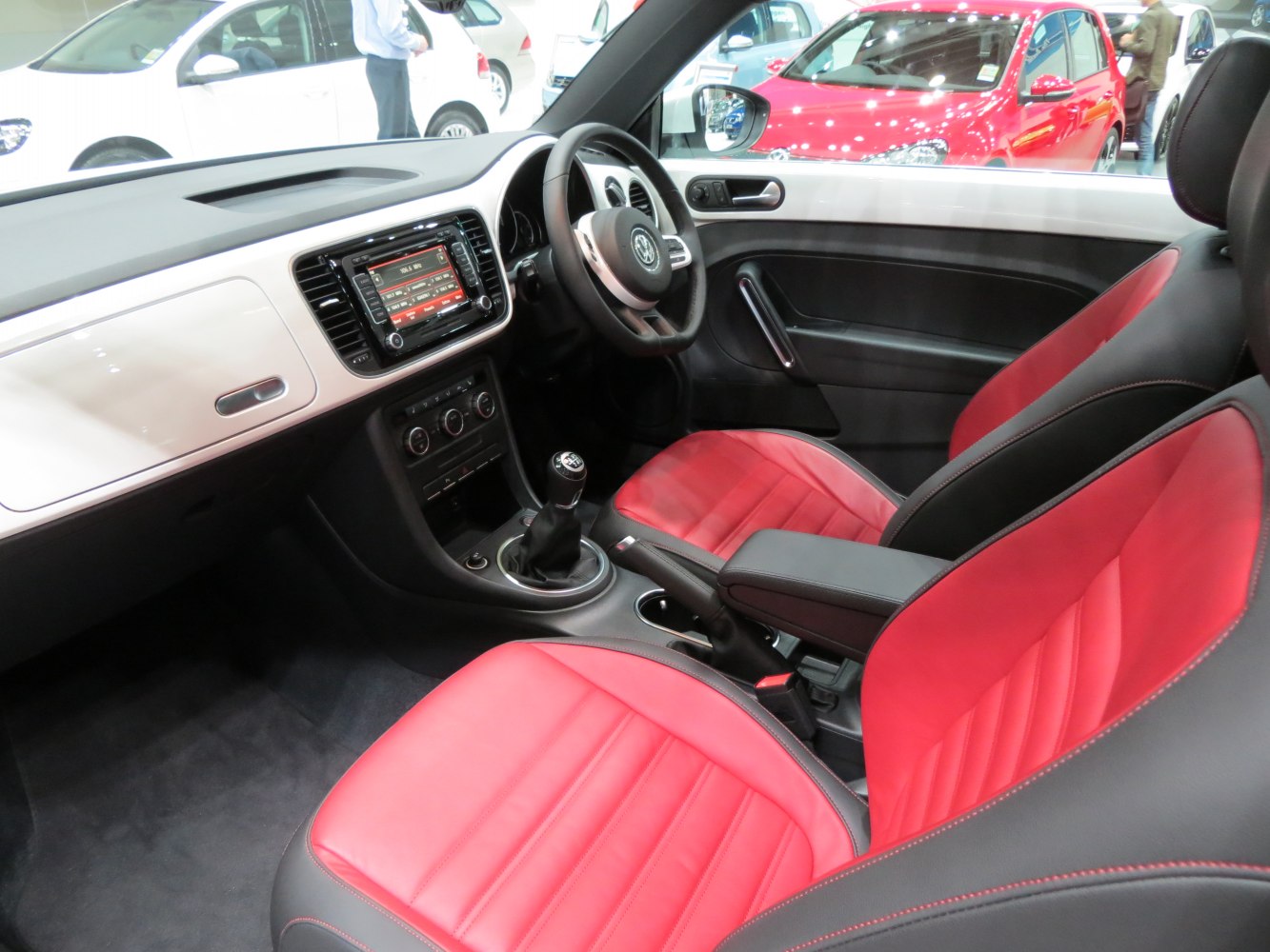 Red leather seats and manual gearbox interior with modern dashboard design