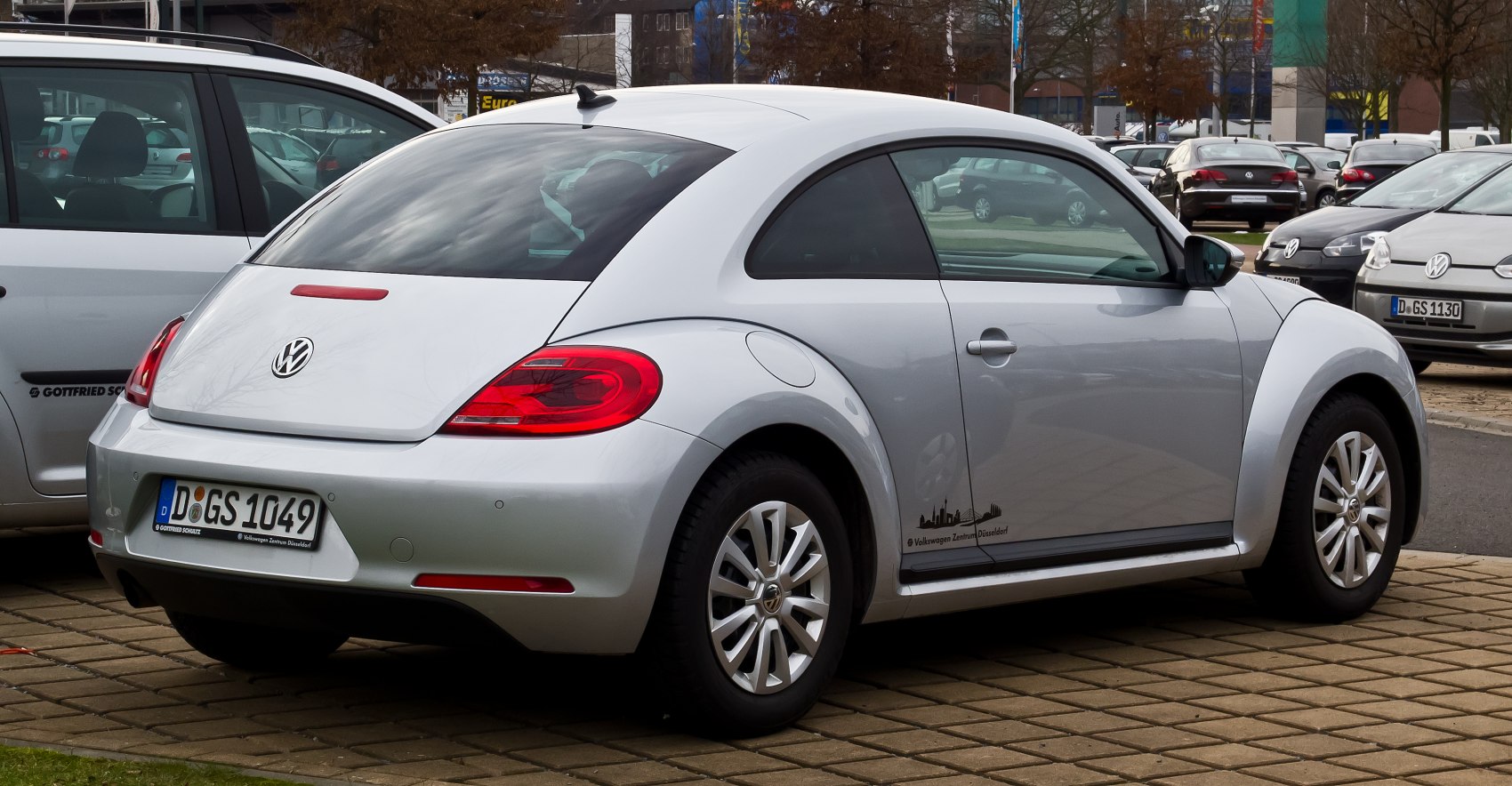 Silver compact hatchback with curved rear fenders and alloy wheels