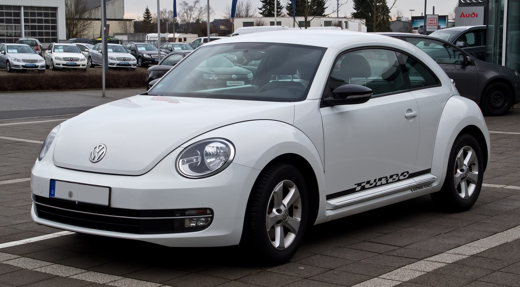 White compact car with retro-modern styling and Turbo decal