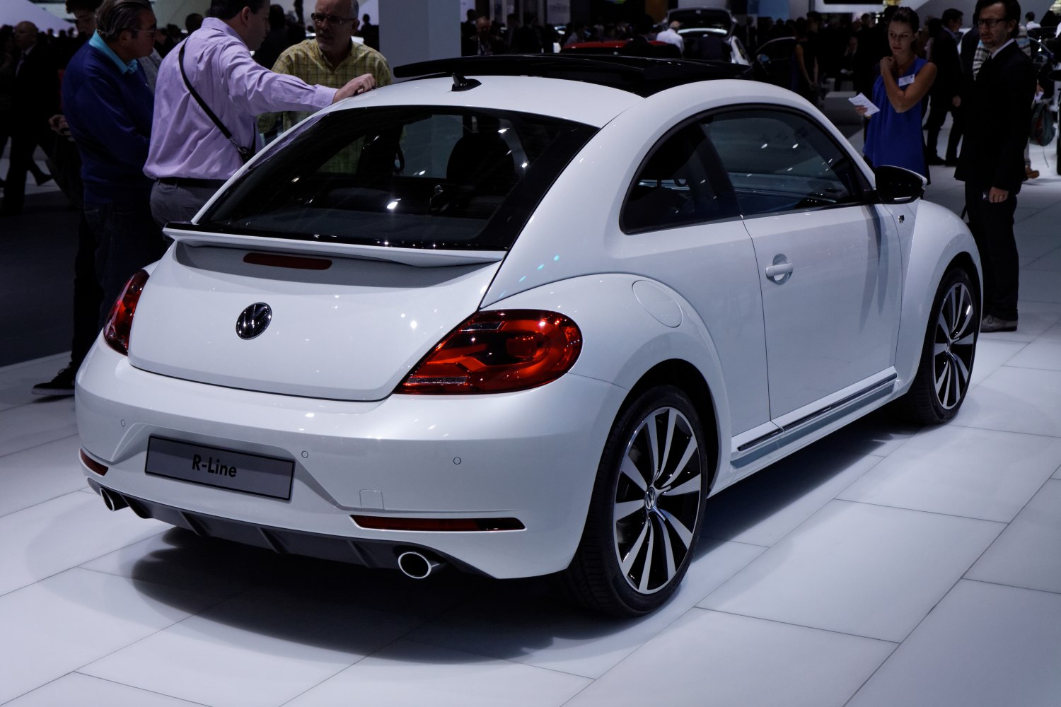 Rear side view with tail lights, alloy wheels, and rear spoiler
