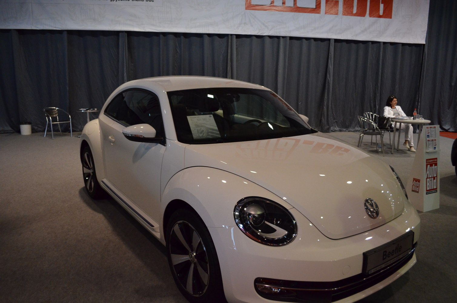 White compact coupe with round headlights and retro-modern design