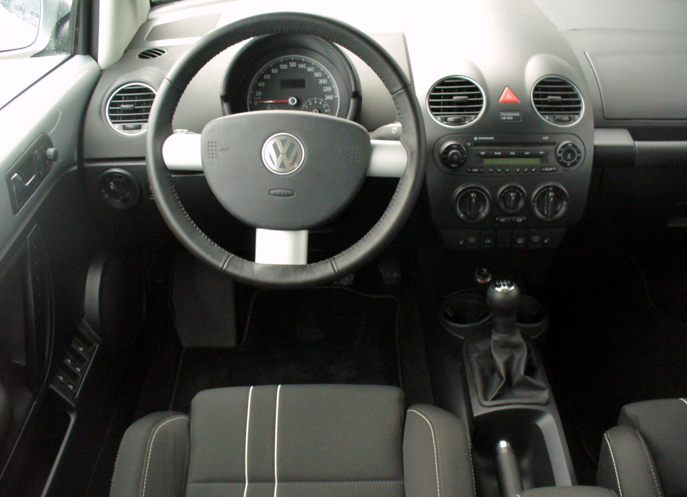 Steering wheel, dashboard, manual gear shift interior view