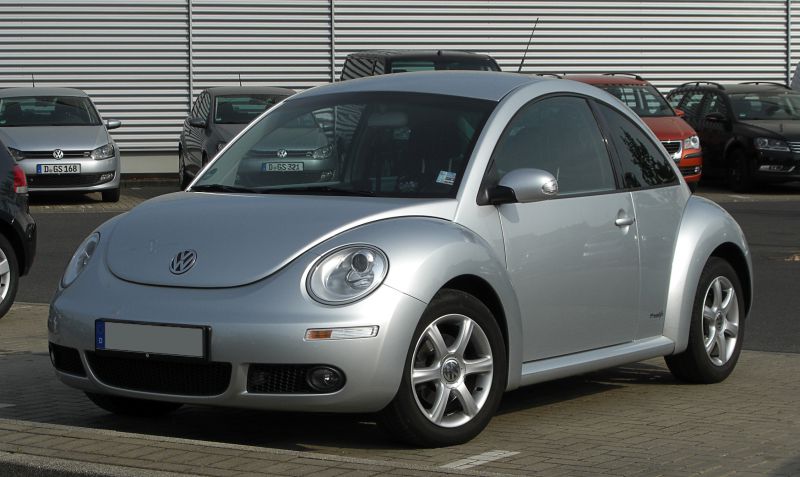 Silver compact hatchback with rounded front and distinctive headlights.