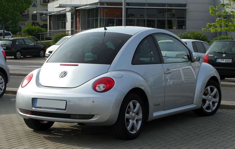 Rear side view with round tail lights and hatchback design
