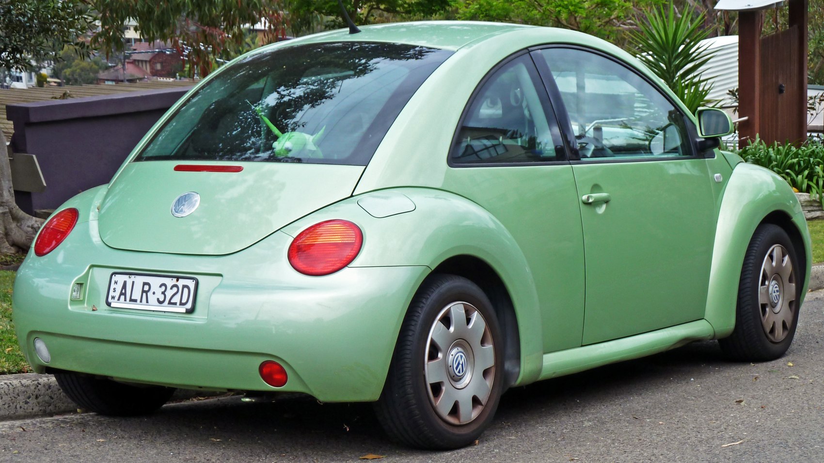 Rounded rear and passenger side of compact hatchback with red tail lights