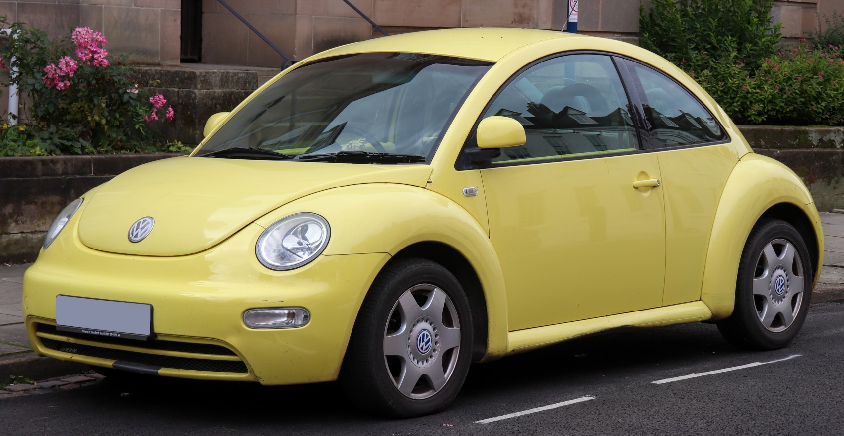 Yellow hatchback with rounded retro body and single-door side profile