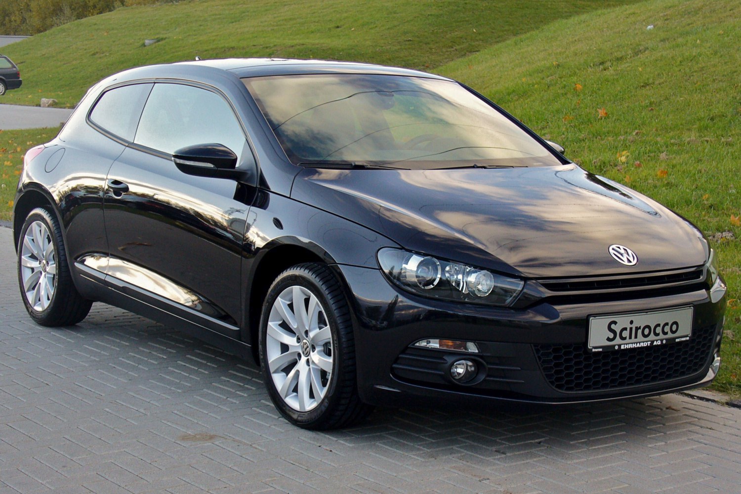 Front-side view of a black sports coupe with alloy wheels