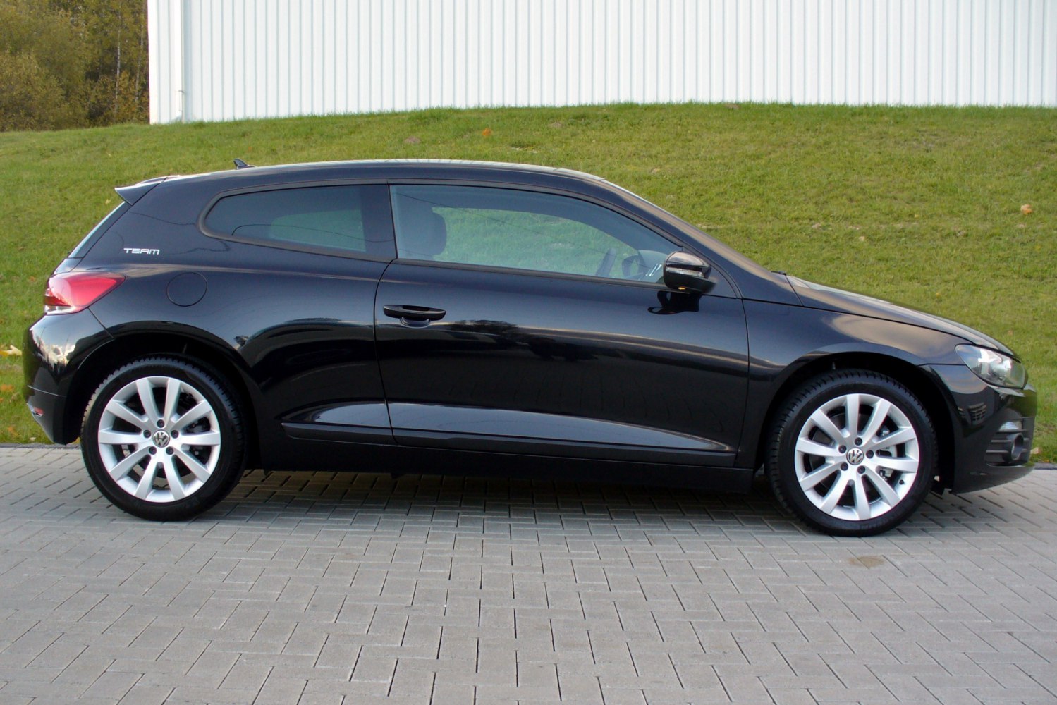 Side profile of a two-door coupe with alloy wheels