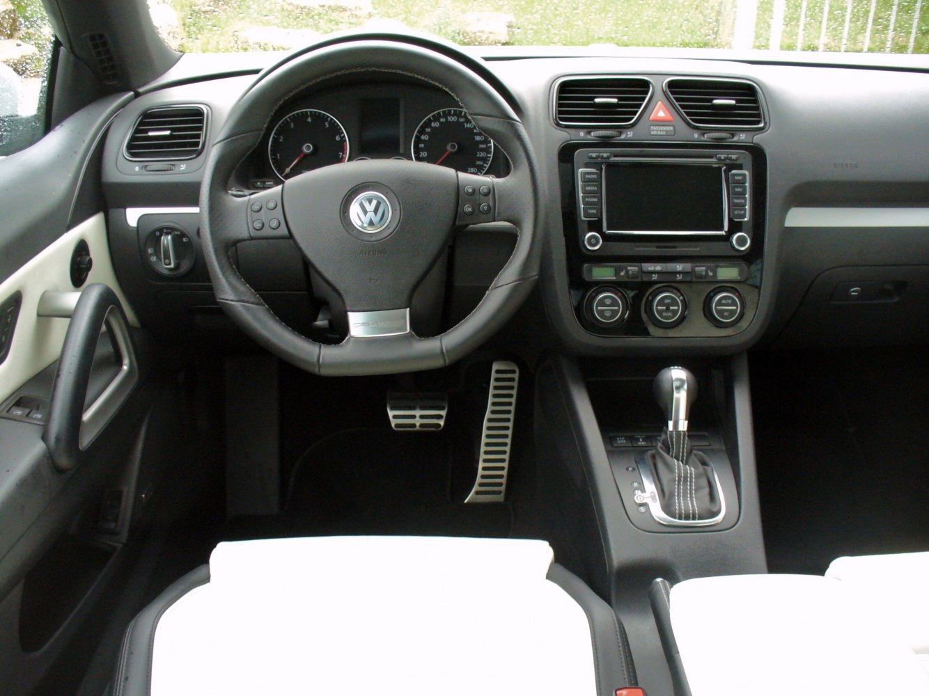 Dashboard and steering wheel with pedals and gear shift