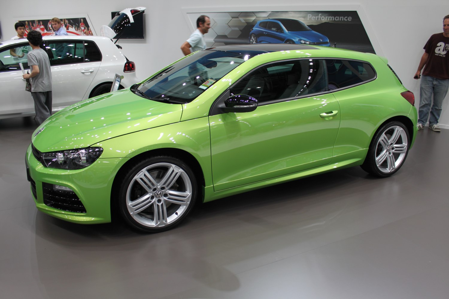 Lime green sporty hatchback with alloy wheels and tinted windows