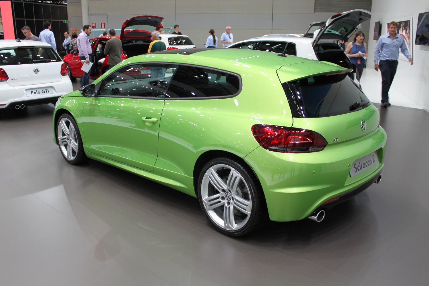 Green sporty hatchback rear-side view with alloy wheels