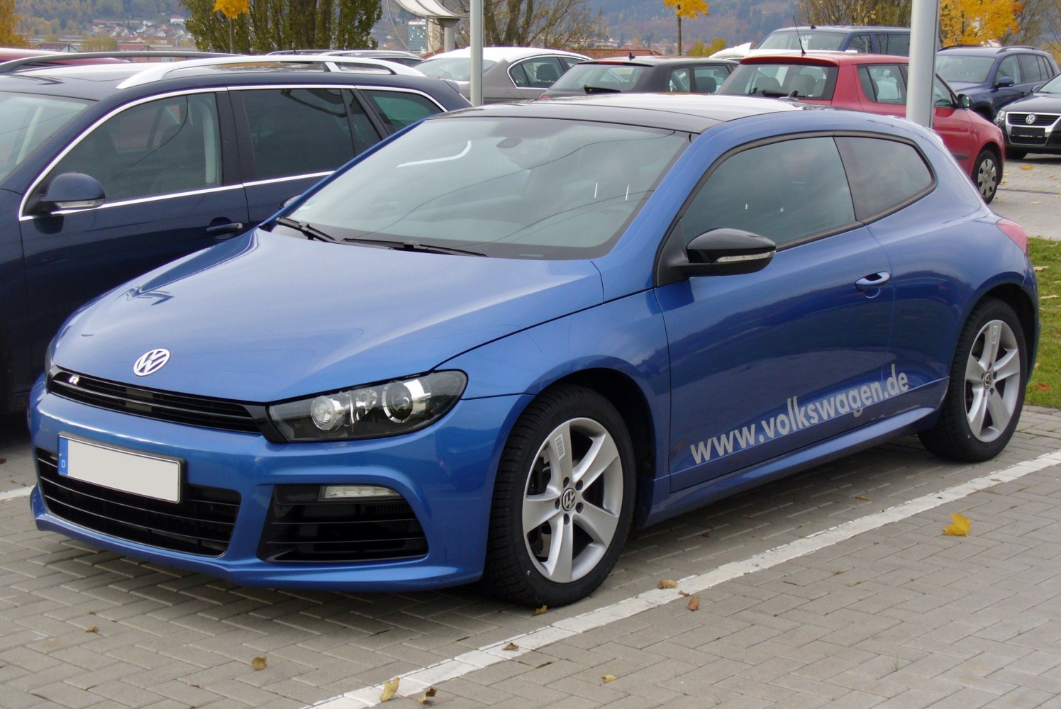 Blue 3-door hatchback with sleek headlights and alloy wheels