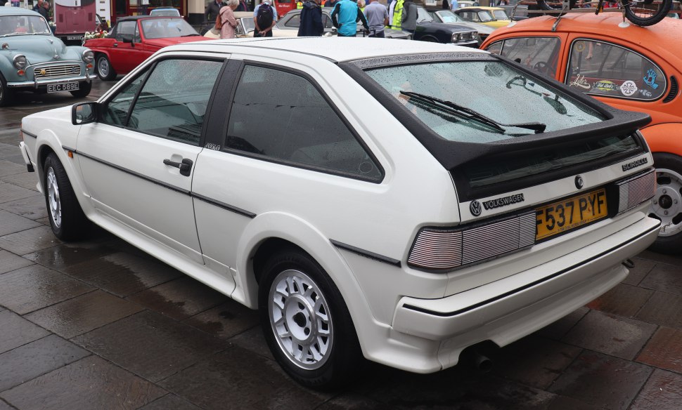 White classic hatchback showing rear with spoiler and tail lights