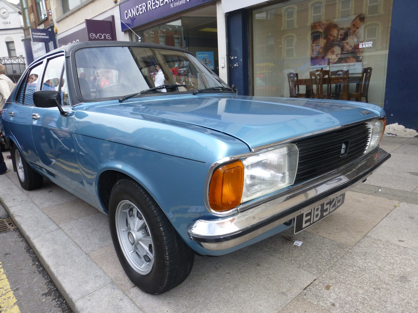 Front view of a classic sedan with chrome bumper and alloy wheels