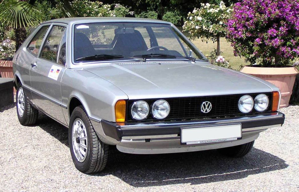 Front view with quad round headlights and angular coupe body.