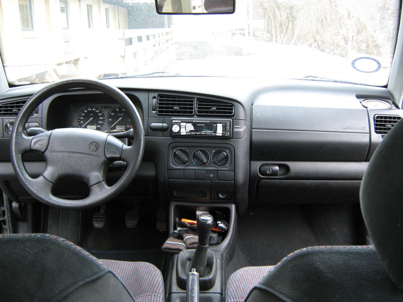 Interior dashboard, steering wheel, and manual gear shift
