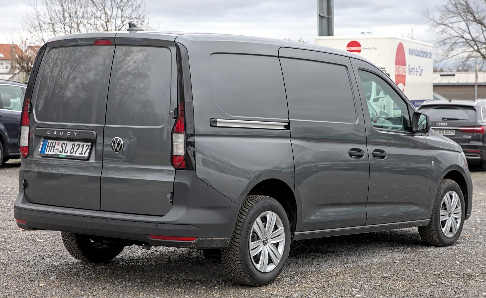 Rear view of gray van with split rear doors and side sliding doors