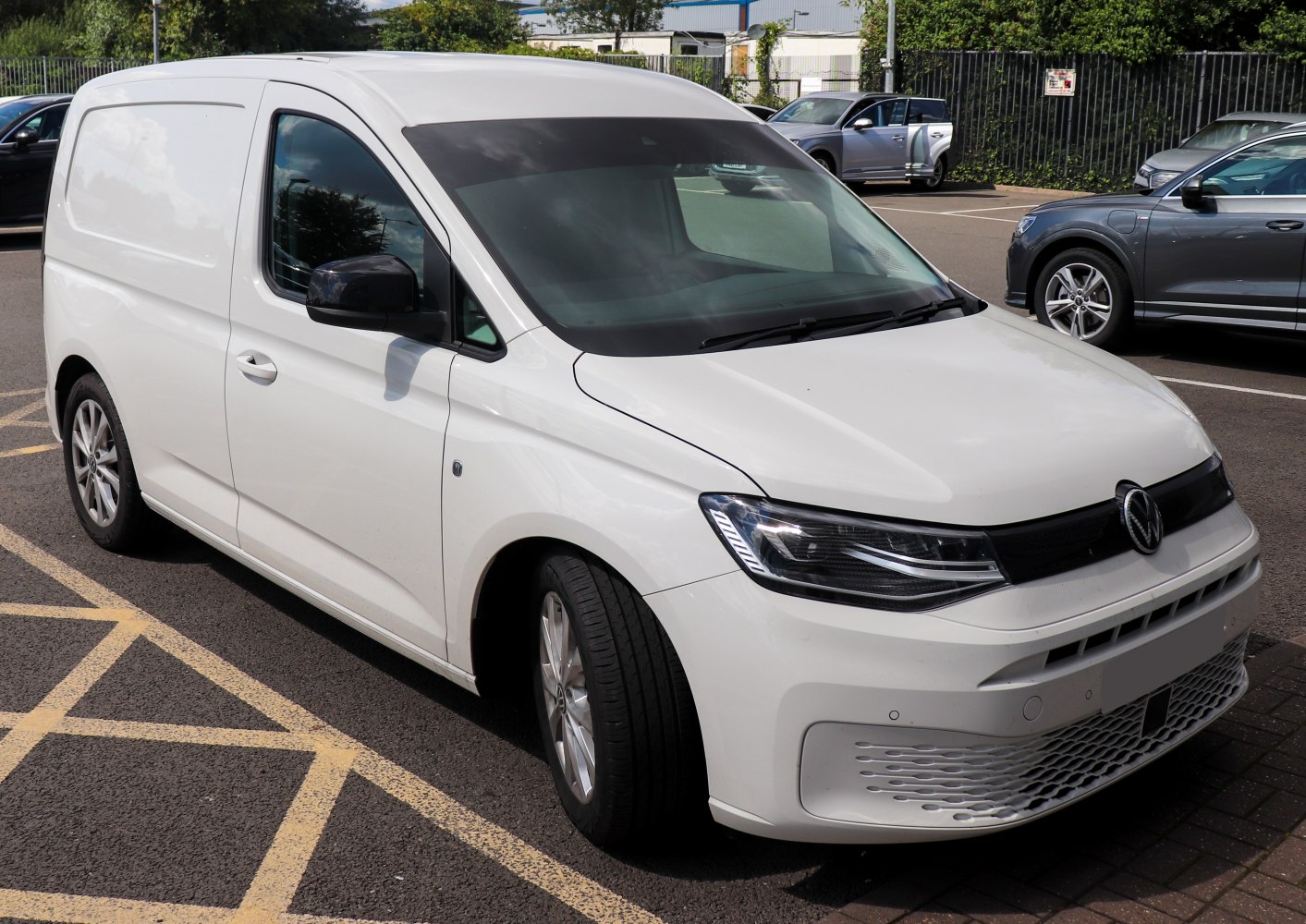 Compact white cargo van with modern headlights and sleek front design